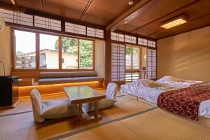Voodi või voodid majutusasutuse Arifuku Onsen Yoshidaya toas