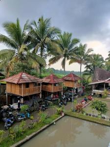 an aerial view of a resort with palm trees at Noor Homestay Tetebatu in Tetebatu +26 photos