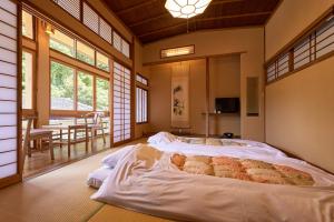 Voodi või voodid majutusasutuse Arifuku Onsen Yoshidaya toas