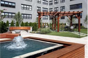 a fountain in a garden with a wooden pergola at Avenue A821 I Cozy And Comfy Philadelphia Stay in Philadelphia