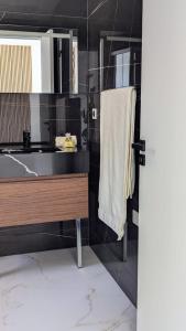 a bathroom with a sink and a shower at Olive Grove Retreat in La Trinité +17 photos