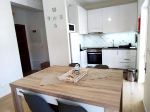 a kitchen with a wooden table with a bottle of water on it at Casa da TITA in Vila Praia de Âncora