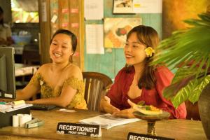 two women sitting at a table in a restaurant at Bali Telaga Hati Yoga Healing And Retreat Center Hostel in Sanur +153 photos