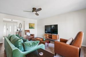 a living room with a couch and a tv at Waterfront Retreat By Henn House Properties in Cheboygan