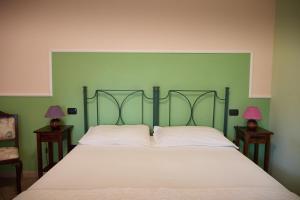 a bedroom with a large bed with two lamps on tables at Da Carla in Santa Maria degli Angeli