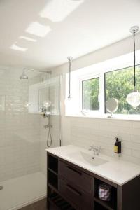 a white bathroom with a sink and a shower at Stone Gate lodge with Private Hot Tub in Boardmills +36 photos