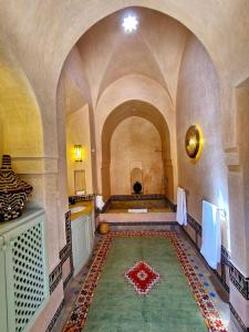 a room with arches and a rug on the floor at LA PORTE AU LION - Marrakech in Marrakesh