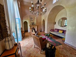 a large living room with a chandelier and a couch at LA PORTE AU LION - Marrakech in Marrakesh +24 photos
