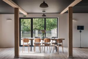 a dining room with a table and chairs and a large window at Heima in Zawoja