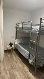a room with two bunk beds and a table at MRS El mirador de la Alcazaba in Antequera