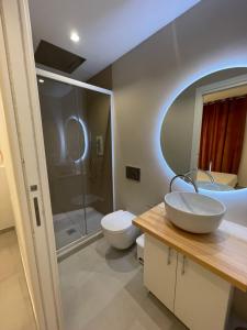 a bathroom with a sink and a toilet and a shower at Residenza Leonina in San Martino in Pensilis +15 photos
