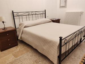 a bedroom with a bed and two night stands at Dimora '900 in Poggiorsini +7 photos