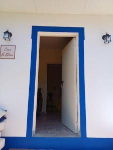 an open door to a hallway in a room at Casa Vó Elisa com piscina privada in São Bartolomeu de Messines +16 photos