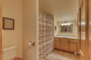 a bathroom with a shower with a toilet and a sink at 460 Hills Circle in Nutria +42 photos
