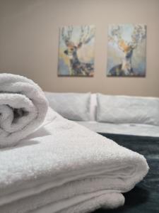 a bed with white towels on top of it at ACasa in Sant Llorenc de Morunys