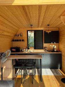 a kitchen with a large island in a room with wooden ceilings at ELLO cottage Kazbegi in Kazbegi