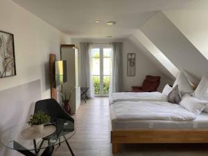 a living room with a bed and a glass table at Ferienwohnung Weingut Sturm in Buergstadt