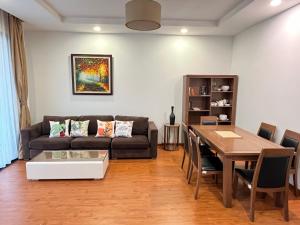 a living room with a couch and a table at Park 12 Homestay in Hanoi