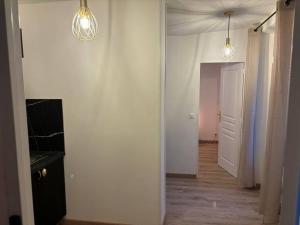 a hallway with two lights on the wall and a door at Le Chic & Relax, proche Centrex in Noisy-le-Grand