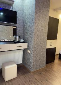 a room with a counter and a tv on a wall at Hotel Premium Armenia in Yerevan