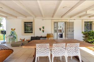 a living room with a wooden table and chairs at Casa Relax - Bellavista Sauna & SPA by TrulloVista in Martina Franca