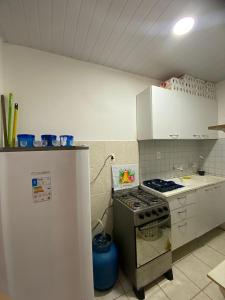 a kitchen with a stove and a refrigerator at Pousada Oásis in Fortaleza +25 photos