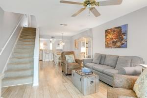 a living room with a couch and a staircase at Mariners Cay 74 in Folly Beach
