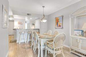 a kitchen and dining room with a table and chairs at Mariners Cay 74 in Folly Beach +27 photos
