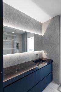 a bathroom with a blue sink and a mirror at Suite Appartement 713 in Ascona