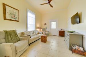a living room with a couch and a tv at Cozy Thomasville Cottage - Walk to Downtown! in Thomasville