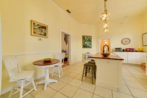 a kitchen with a table and a table and chairs at Cozy Thomasville Cottage - Walk to Downtown! in Thomasville