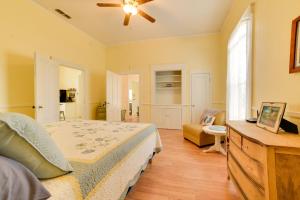 a bedroom with a bed and a couch at Cozy Thomasville Cottage - Walk to Downtown! in Thomasville