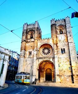 an old church with a bus in front of it at Apartamento Alfama - Lisbon in Lisbon