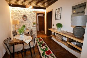 a dining room with a table and chairs and a table and a dining room at Ador Boutique Hotel in Berat