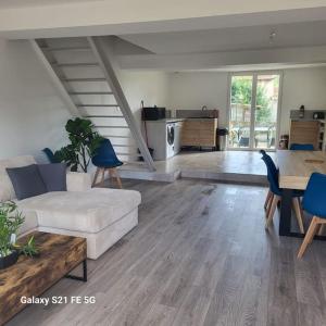 a living room with a couch and a table at Maison 3 chambres avec jardin in Bouxières-aux-Dames