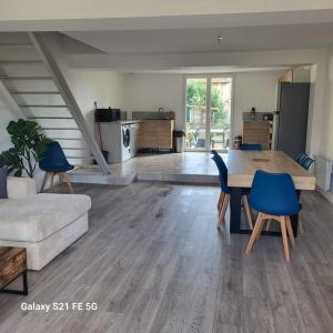 a living room with a table and a couch at Maison 3 chambres avec jardin in Bouxières-aux-Dames +12 photos