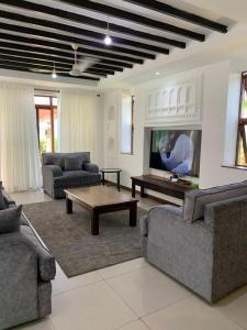 een woonkamer met twee banken en een salontafel bij Luxurious Beachfront Villa with Private Pool - Sultan Palace in Kilifi