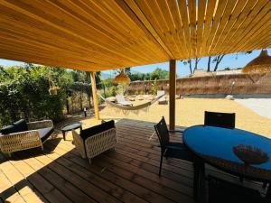 a wooden deck with a blue table and chairs at Casa Figarella in Calenzana