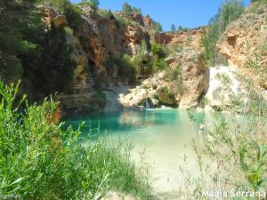 a river in a canyon with blue water at Casas rurales La Fuente I in Villora