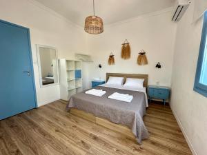 a bedroom with a bed with two towels on it at Assamaris Beachfront House in Asprovalta