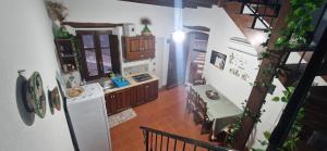 an overhead view of a kitchen with a table and a refrigerator at Domus de Jara - Casa Montis in Baradili