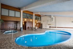 a large blue tub in front of a building at Pool, Hot Tub, Sauna, Amazing Ski Area Views, Partially Covered Patio in Steamboat Springs