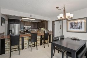 a kitchen and dining room with a table and chairs at Pool, Hot Tub, Sauna, Amazing Ski Area Views, Partially Covered Patio in Steamboat Springs +38 photos