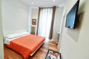 a bedroom with a bed and a flat screen tv at Alsecondopiano B&B in Gioia del Colle +20 photos