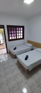 Rúm í herbergi á Hotel Marambaia Ponta Porã