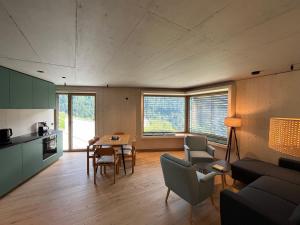 a living room with a couch and a table with chairs at Walsergrat Appartements in Laterns