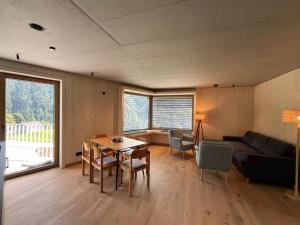 a living room with a table and a couch at Walsergrat Appartements in Laterns