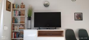 a flat screen tv sitting on a white entertainment center at Hidden Dream Place Sarajevo in Sarajevo