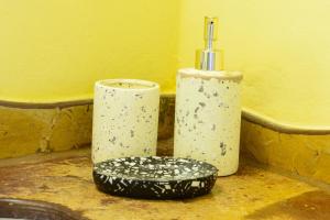 a couple of vases sitting next to a sink at Pousada Vila Serrano in Lençóis