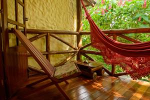 a hammock sitting on the porch of a house at Pousada Vila Serrano in Lençóis